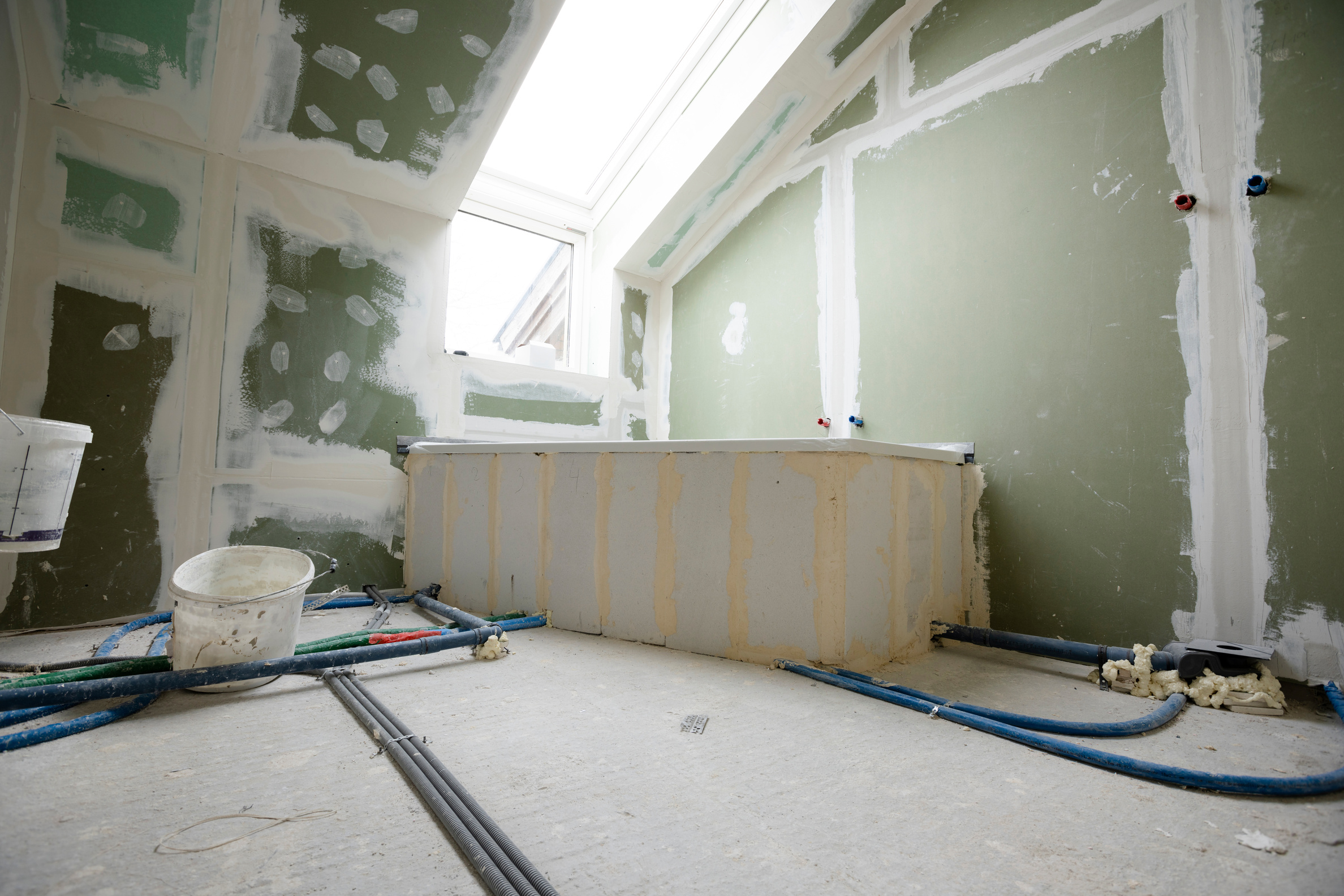 Attic finishing construction site in the phase drywall spackling and plastering before screeding